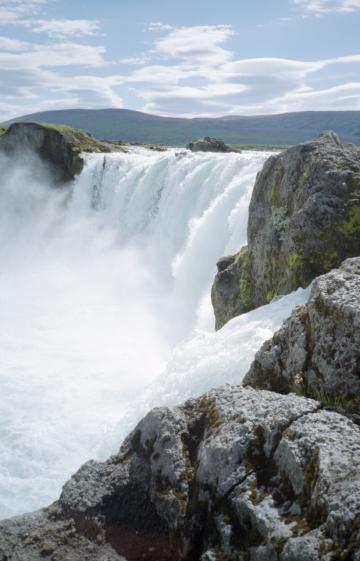 The view across the waterfalls at Go�afoss with rocks in the foreground and sky in the background