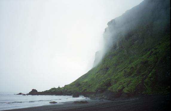 The black sands of the beach at V�k with mist hanging over the cliffs